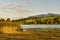 Lake in the evening mood in the Alps with reeds and moor grass in the foreground