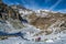 Lake Fiorenza covered with ice on the slopes of Monviso