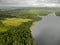 Lake in forest with cloudy sky. Aerial view Russian Karelia. lonely farm house