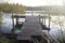 lake in the forest. morning sun, wooden gangway to a wooden pier on the lake