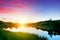 Lake in forest at sunset. Romantic sky