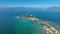 LAKE GARDA, ITALY - APRIL, 2023: Aerial view of a coastline of Lake Garda. drone shot of lake near city and mountains