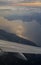 Lake Garda and winglet on sunset view from airplane porthole