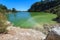 A lake in a geothermal zone, being colored yellow-green by sulfur