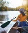 The lake is her place she goes to breakaway. a young woman going for a canoe ride on the lake.