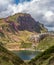 Lake, hiking track and clouds vertical composition