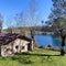 The lake House. Autumn image with lots of sunlight highlighting its 3 elements, tree, lake and house.