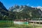 Lake Koenigssee with rocks and excursion boat in the Berchtesgaden Alps, Germany