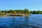 Lake Ladoga on clear day, stone islands covered with forest, Karelia. The majestic Transfiguration Cathedral rises above the