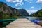 Lake landscape with canoes, kayak, mountains and forest in a sunny summer day with some clouds