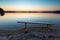 Lake landscape at sunset with bench