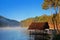 Lake, little houseboat and pine forest