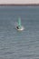 Lake Macquarie, NSW/Australia - December 2018: Mature adult in his fifties speeding into shore on the short board windsurfer,