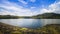 Lake with mountain under cloudy sky