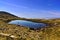 Lake in the mountains with hiker, Applecross, Wester Ross, Scotland