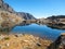 Lake in mountains. Pond in Valley of Five Spis Lakes surrounded by rocky summits, High Tatra Mountains