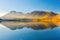 Lake and mountains in a valley at dawn. Reflections on the surface of the lake.