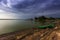 Lake Musov - green fishing boat on the shore of the lake with dramatic heavy clouds in the sky