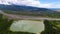 Lake near green trees, valley with houses and mountain Georgia, beautiful nature