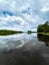 Lake Nokomis, Tomahawk, Wisconsin, lake reflecting clouds on a calm summer day
