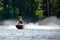 Lake Nokomis, Tomahawk, Wisconsin, USA, August, 20, 2022 - Girl on a jet ski flying across the lake