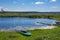 Lake with old boats, forest, church