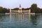 Lake at the park of Buen Retiro with monument of Alfonso XII King of Spain at sunset, Madrid, Spain