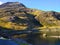 Lake and a pathway with people walking and mountains at the background in Snowdonia National Park in Wales