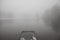 Lake pier, winter and heavy fog