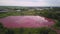 Lake with pink water in industrial zone, aerial view, pollution by toxic chemicals