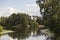 Lake pond surrounded by woods trees with green leaves foliage.  Landscape panorama at  Serebryany Bor Silver pinewood forest