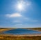 Lake among prairies at sunny day