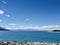 Lake Pukaki, sky, rocks and mountain.