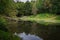 Lake with quiet water reflecting the natural environment as a mirror in Fairy Glen Falls, Highlands, Rosemarkie, Scotland