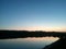 Lake reflecting sunset with colored clouds in the forest