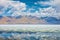 Lake with reflection of mountains and clouds on water