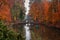 Lake reflections of fall foliage and ancient bridge in Ukraine