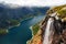 Lake Ringedalsvatnet, snow covered mountains and a waterfall, Norway