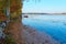 Lake shore on the autumn time on a sunset. Autumn leaves in water.