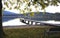 Lake shore with bench and landing stage in beautiful evening light