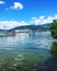 Lake shore with debris and boats docked.