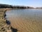 Lake shore spring march landscape blue sky background