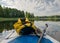 Lake shore view, foreground sup board bow with yellow waterproof bag, summer