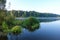 Lake with a smooth surface and reeds reflected in the water