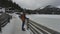 Lake Spitzingsee in winter covered with snow and ice in freezing cloudy weather in Bavaria, Germany. A mountain lake in