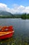 Lake StrbskÃ© pleso and a hotel in the High Tatras, Slovakia. Orange boats in front
