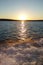 Lake sunset with boat wake waves