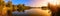 Lake sunset panorama in gold and blue