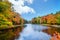 Lake surrounded by fall foliage colors in New England autumn