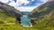 Lake surrounded by hills and greenery in the Kaprun high mountain reservoirs, Austria